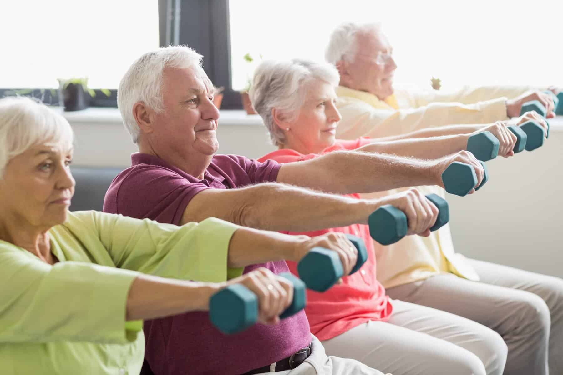 Seniors Using Weights Assisted Living Activities At Birkwood Village